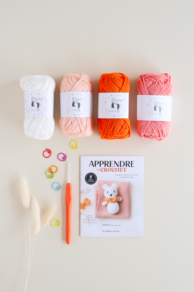 Kit pour apprendre le crochet avec pelotes de coton colorées, crochet, marqueurs de mailles et livret explicatif pour réaliser un petit koala au crochet.