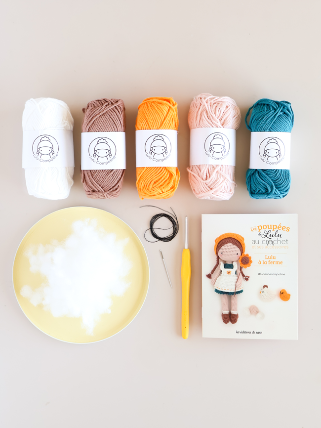 Kit crochet Lulu à la ferme de Lulu Compotine avec pelotes de coton colorées, crochet, rembourrage et livret explicatif pour réaliser une poupée Lulu et ses accessoires au crochet.